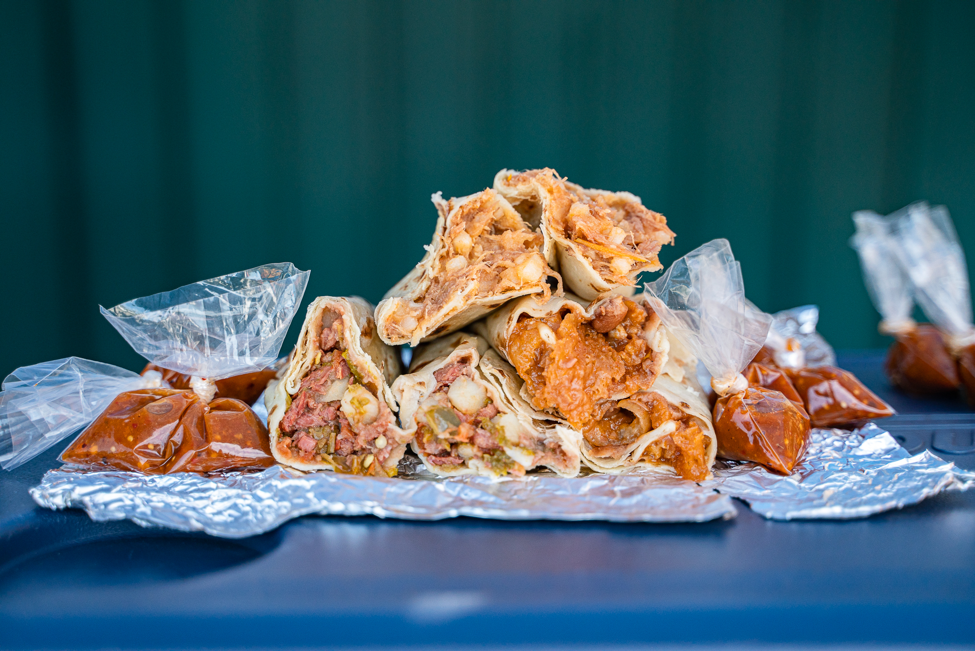 A pile of different burritos form El Cachanilla Burritos. Photo by Memo Torres for L.A. TACO.