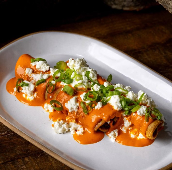 2 orange salsa-covered flautas de camote by Wes Avila.